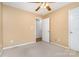 Cozy bedroom with neutral tones, plush carpeting, ceiling fan, and multiple closets for ample storage space at 1318 Candlewood Dr, Gastonia, NC 28052