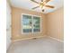 Bright bedroom featuring plush carpet, neutral paint, ceiling fan, and a window providing lots of natural light at 1318 Candlewood Dr, Gastonia, NC 28052