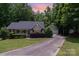 Lovely home with a detached garage and long driveway, surrounded by mature trees and a beautifully landscaped yard at 1318 Candlewood Dr, Gastonia, NC 28052