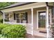 Inviting front porch with rocking chairs, hanging plants, and classic white columns, perfect for relaxing at 1318 Candlewood Dr, Gastonia, NC 28052