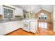 Bright kitchen boasts white cabinets, granite countertops, and hardwood floors at 1318 Candlewood Dr, Gastonia, NC 28052
