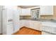 Corner kitchen features white cabinets and modern appliances near a bright window at 1318 Candlewood Dr, Gastonia, NC 28052