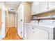 Laundry area with washer, dryer, and overhead cabinets for extra storage at 1318 Candlewood Dr, Gastonia, NC 28052