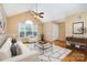 Bright living room with vaulted ceilings, large windows, and stylish decor, creating a welcoming atmosphere at 1318 Candlewood Dr, Gastonia, NC 28052