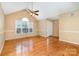 Spacious living room featuring hardwood floors, vaulted ceilings, and a large window for plenty of natural light at 1318 Candlewood Dr, Gastonia, NC 28052