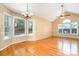 Spacious living room with vaulted ceilings, hardwood floors, and large windows for ample natural light at 1318 Candlewood Dr, Gastonia, NC 28052