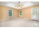 Spacious primary bedroom with a tray ceiling and natural lighting at 1318 Candlewood Dr, Gastonia, NC 28052
