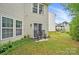 Backyard with a seating area, well-maintained lawn, home exterior with sliding glass doors, and mature trees at 1332 Waterlily Ln, Charlotte, NC 28262