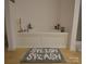 Bathroom featuring a large soaking tub with a tiled surround, complemented by a gray rug with a fun design at 1332 Waterlily Ln, Charlotte, NC 28262