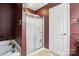 Bathroom featuring a walk-in shower with glass doors and a white en-suite door at 1332 Waterlily Ln, Charlotte, NC 28262