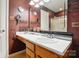 Bathroom featuring a white countertop, framed mirror and storage cabinets at 1332 Waterlily Ln, Charlotte, NC 28262