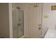 Bathroom features a glass-enclosed shower stall and a convenient door, combining functionality with simple design elements at 1332 Waterlily Ln, Charlotte, NC 28262
