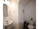 Bright bathroom features a toilet, sink, and a round mirror at 1332 Waterlily Ln, Charlotte, NC 28262