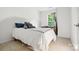 Comfortable bedroom featuring a bed, neutral walls, and a window with natural light at 1332 Waterlily Ln, Charlotte, NC 28262