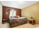 Bedroom with a queen sized bed, warm neutral toned walls and a large window providing natural light at 1332 Waterlily Ln, Charlotte, NC 28262