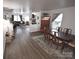 Open-concept dining area with modern flooring and a view of the living room at 1332 Waterlily Ln, Charlotte, NC 28262