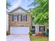 Charming two-story home with brick accents, manicured lawn and attached two car garage at 1332 Waterlily Ln, Charlotte, NC 28262