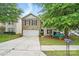 Charming two-story home with a well-maintained lawn, inviting front porch area, and two car garage at 1332 Waterlily Ln, Charlotte, NC 28262