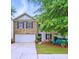 Charming two-story home featuring a brick facade, a two-car garage and a well maintained front yard at 1332 Waterlily Ln, Charlotte, NC 28262