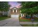 Charming two-story home with a well-maintained lawn, inviting front porch area, and two car garage at 1332 Waterlily Ln, Charlotte, NC 28262