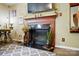 Close-up of a beautifully adorned fireplace with a dark surround, complemented by plants and decorative items at 1332 Waterlily Ln, Charlotte, NC 28262