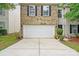 A spacious two car garage with well manicured lawn at 1332 Waterlily Ln, Charlotte, NC 28262