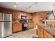 Functional kitchen featuring stainless steel appliances, oak cabinets, and a practical layout for cooking at 1332 Waterlily Ln, Charlotte, NC 28262