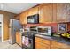 Well-equipped kitchen with oak cabinets, modern appliances, and countertop space at 1332 Waterlily Ln, Charlotte, NC 28262