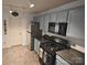 Kitchen features a black gas stove and stainless steel refrigerator at 1332 Waterlily Ln, Charlotte, NC 28262