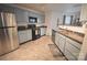 Well-lit kitchen with stainless steel refrigerator, gas stove, and light blue cabinets at 1332 Waterlily Ln, Charlotte, NC 28262