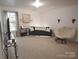 Bright living room featuring modern furniture, neutral walls, decor, carpet, and a window with natural light at 1332 Waterlily Ln, Charlotte, NC 28262