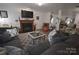 Comfortable living room featuring a fireplace, hardwood floors, and ample seating at 1332 Waterlily Ln, Charlotte, NC 28262