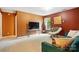 Cozy living room area with comfortable seating, accent wall, and entertainment center at 1332 Waterlily Ln, Charlotte, NC 28262