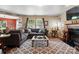 Comfortable living room featuring a fireplace, large windows, and plush seating for ultimate relaxation at 1332 Waterlily Ln, Charlotte, NC 28262