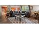 Comfortable living room featuring a gray sectional sofa, stylish rug, and an inviting view into the adjacent rooms at 1332 Waterlily Ln, Charlotte, NC 28262