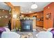 Cozy living space with a fireplace, comfortable seating, and a view into the adjacent kitchen area at 1332 Waterlily Ln, Charlotte, NC 28262