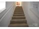 Carpeted staircase leading to the upper level of the home at 1332 Waterlily Ln, Charlotte, NC 28262