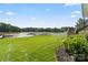A lush green lawn and wooden staircase lead to a private backyard by the lake at 136 Preston Rd, Mooresville, NC 28117