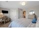 Cozy bedroom with striped bedding, soft textures, and ample space, providing a comfortable and inviting retreat at 136 Preston Rd, Mooresville, NC 28117
