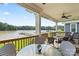 A covered deck offers scenic lake views with a table and chairs for outdoor enjoyment at 136 Preston Rd, Mooresville, NC 28117