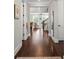 Hallway featuring dark wood floors, leading to the living room and staircase at 136 Preston Rd, Mooresville, NC 28117