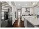 Modern kitchen with stainless steel appliances, white cabinets, and a marble backsplash at 136 Preston Rd, Mooresville, NC 28117