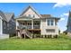 A charming home with a covered deck and stairs leading to a lush, level backyard at 136 Preston Rd, Mooresville, NC 28117