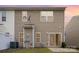 Exterior of a home features tan vinyl siding, a concrete patio, privacy fence and lawn at 13612 Singleleaf Ln, Charlotte, NC 28278