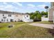 Spacious backyard featuring a grassy lawn, a patio, and a white fence for privacy and relaxation at 13612 Singleleaf Ln, Charlotte, NC 28278