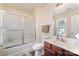 Bathroom with white shower/tub combo, white vanity with wood cabinets and drawers, and a modern toilet at 13612 Singleleaf Ln, Charlotte, NC 28278