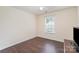 Cozy bedroom features a ceiling fan and wood flooring at 13612 Singleleaf Ln, Charlotte, NC 28278