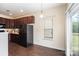 Cozy dining area off the kitchen with view to the backyard and modern flooring at 13612 Singleleaf Ln, Charlotte, NC 28278