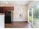 Bright dining area featuring modern flooring and large sliding glass doors to the patio at 13612 Singleleaf Ln, Charlotte, NC 28278