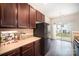 Charming kitchen with access to the backyard patio and featuring a modern refrigerator at 13612 Singleleaf Ln, Charlotte, NC 28278